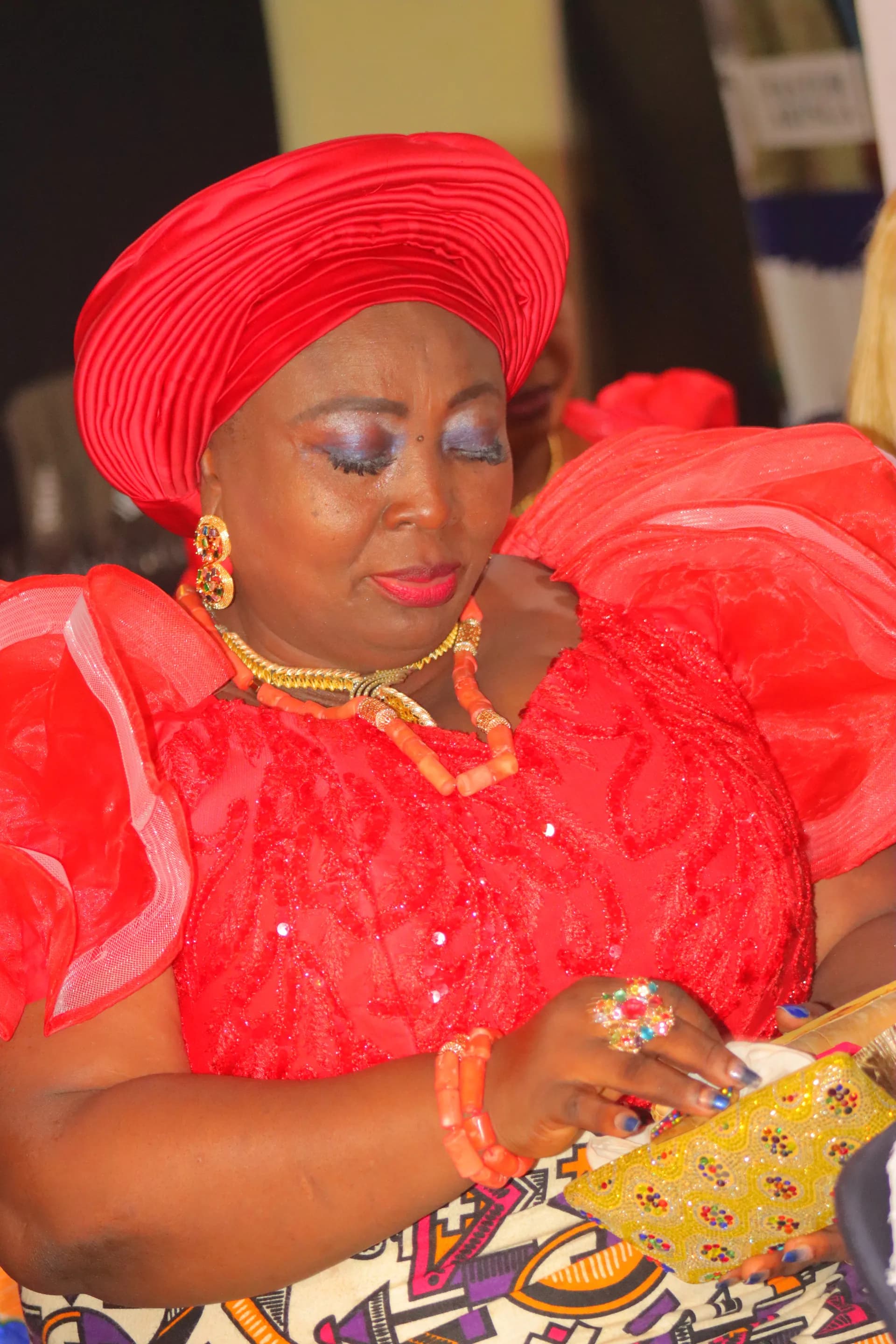 A member joyfully holding her golden offering purse