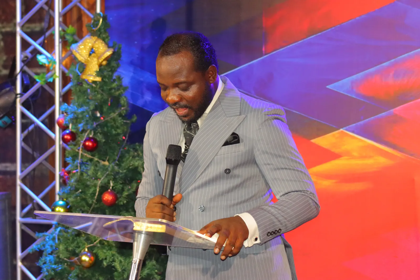 A minister declaring the Word, microphone in hand
