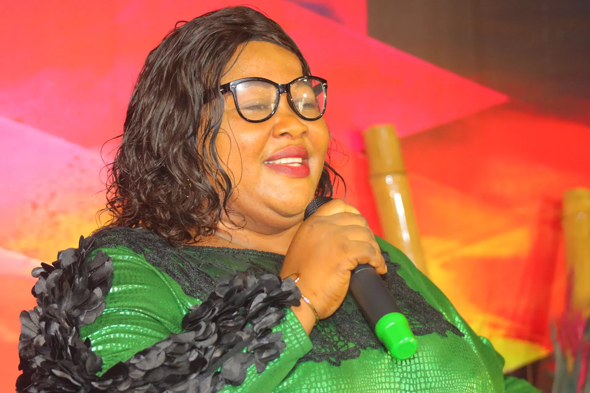 A member of the choir smiling with the microphone