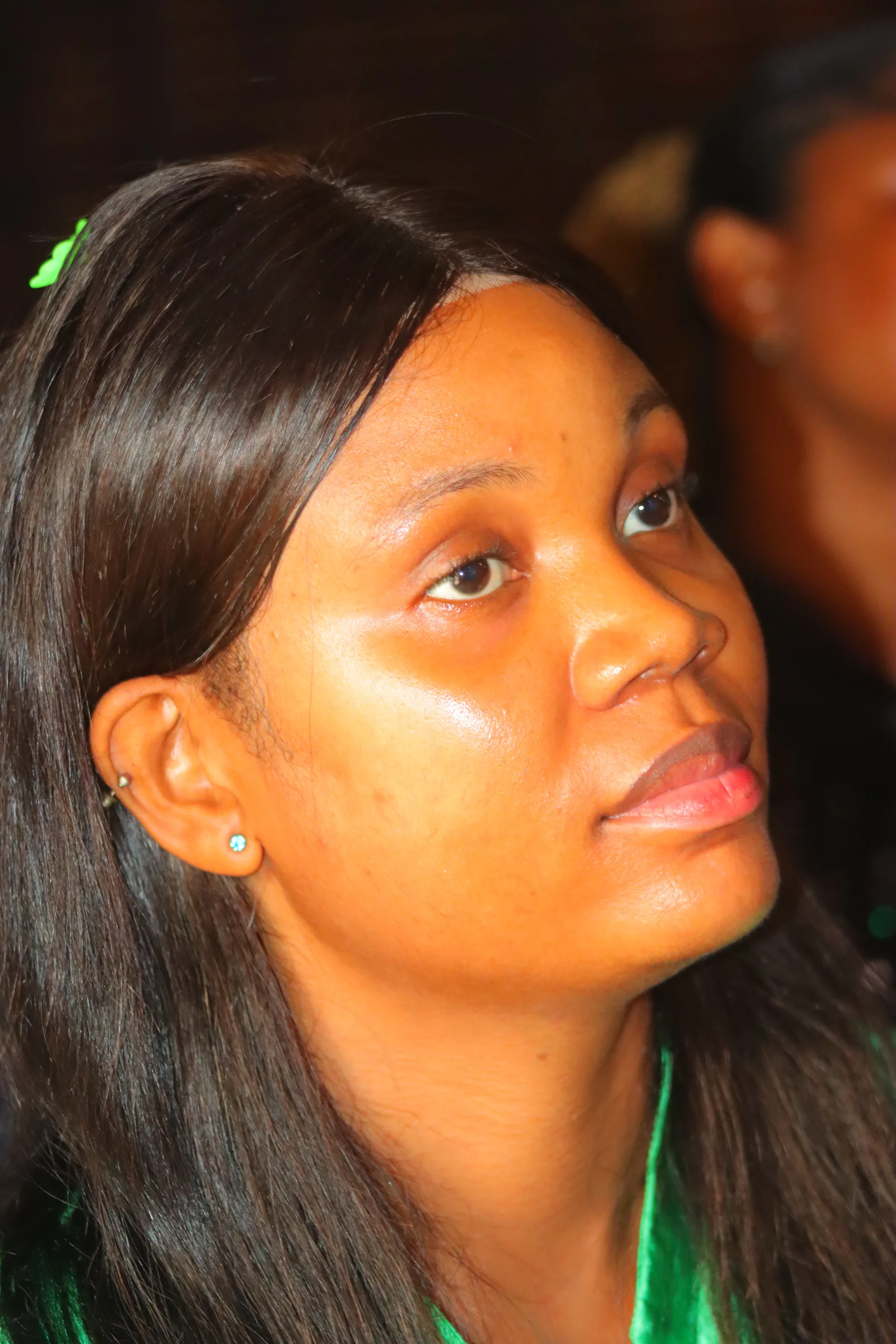 A media team member serving behind the camera